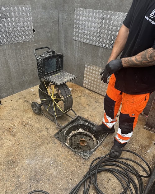 CCTV drain survey equipment inspecting underground pipe system.